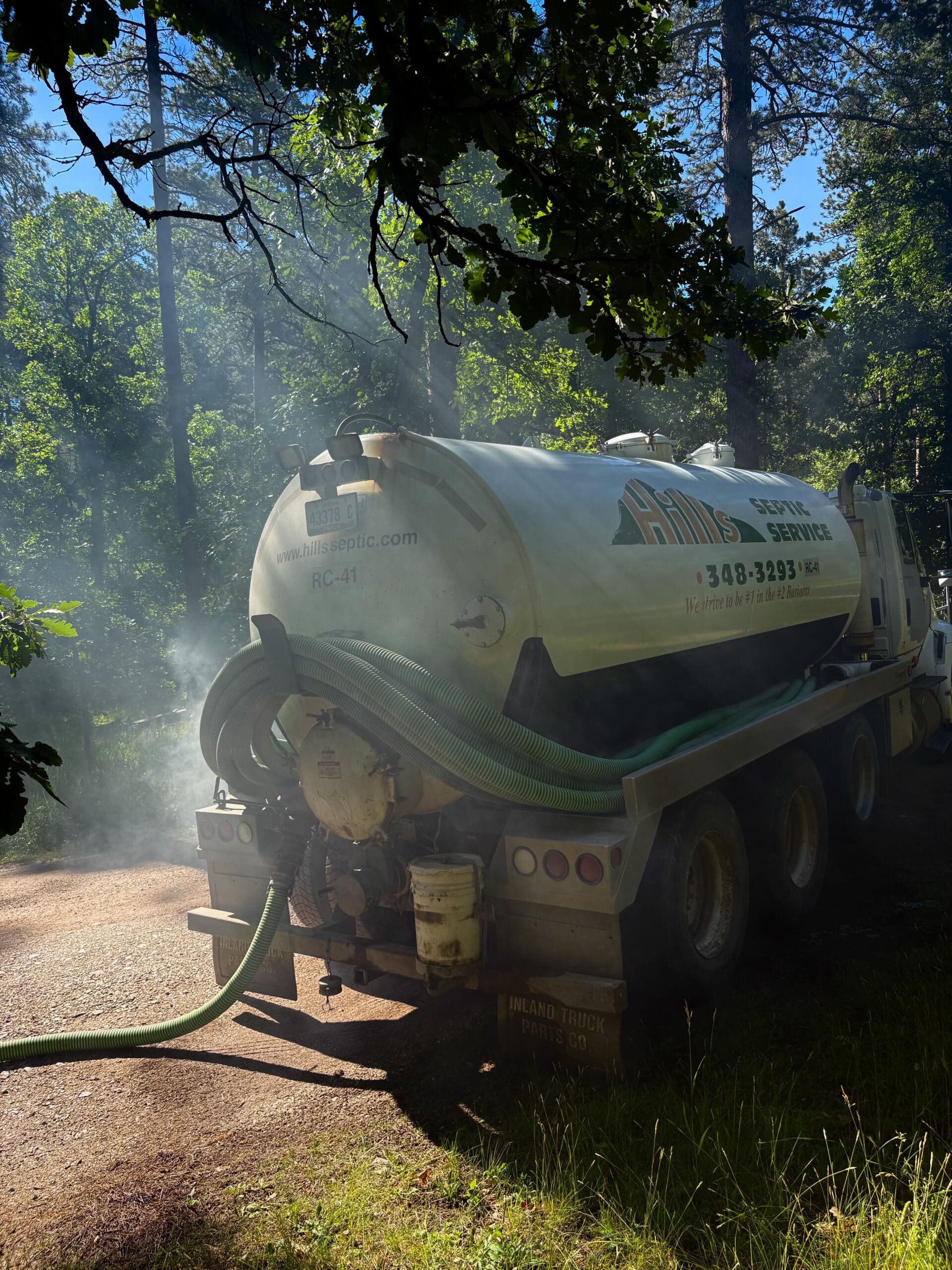Rear angled view of a Hills Septic Service truck